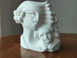 A charming plaster statue of a mother with her child for a fireplace or other interior decoration