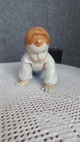 Zsolnay, young child climbing, 10 x 18 x 7 cm, worn mark on right palm