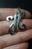 Old silver pendant with an engraved 