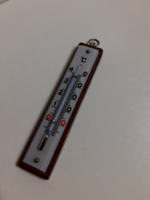 Old wall-hanging small mercury thermometer glass on a measuring sheet with a hardwood back.