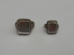 A beautiful antique silver signet ring with a pair of emerald stones
