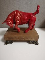 Heavy, solid cast-iron bull statue heated by energy, red bull