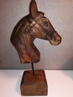 For horse lovers, a beautiful, large hand-carved horse head on a wooden pedestal.