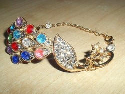 Bracelet with many stones in the shape of a peacock