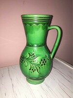 Green colored glazed ceramic jug with flower pattern