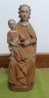 Old carved wooden amulet statue virgin mother with baby