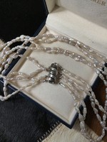4-row string of river pearls with a modern silver clasp