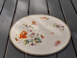 Old majolica plate with a metal frame for serving warm