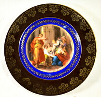 A porcelain decorative plate with historicizing scene marked Alt Wien