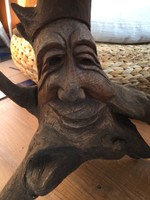 A smiling figure carved from hazel root