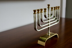 Menorah with 9 branches, gold-silver color.