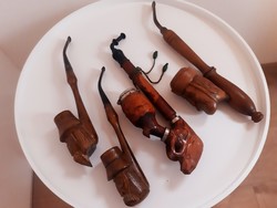 Old carved wooden pipes in a pack