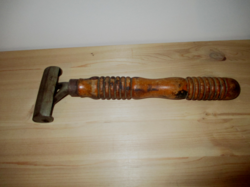 An old tool used for gluing in the wood industry, a scraper