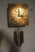 Two-weight wall clock with copper dial.