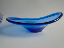 Old, broken blue glass bowl, center of the table.