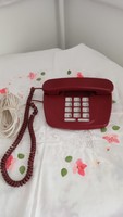 A very old burgundy still landline phone for decoration?