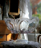 A beautiful cast glass pedestal table centerpiece with colored flowers and blown rim