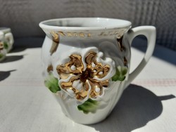 Art nouveau porcelain commemorative mug with embossed floral pattern