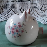 Old porcelain piggy bank with flower pattern