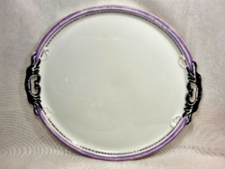 A porcelain cake tray with a relief pattern.