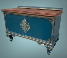 A small chest of drawers with an oriental feel