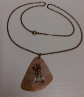 Retro handmade shell pendant with a brass pharaoh figure on a long chain