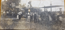 A threshing machine at work, a photo depicting old farm life
