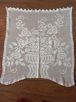 Snow-white, crocheted curtain