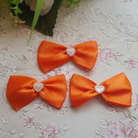 New, handmade orange satin bow ornament, decoration