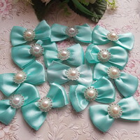 New, handmade mint-colored satin bow ornament, decoration