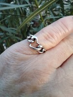 Silver ring with a heart pattern