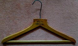 Old wooden hanger with red October clothing factory inscription