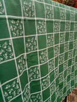 A beautiful green tablecloth with a white pattern