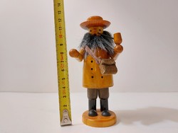 Smoking wooden figure bearded man