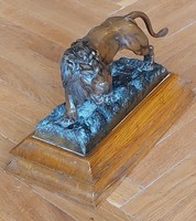 Bronze lion statue, on a wooden pedestal
