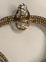 Aranyozott karkötő háromsoros láncon kristályokkal kirakott medállal