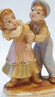 Girl and boy figure. Old, worn piece. 15 Cm. High. Ceramic or porcelain.