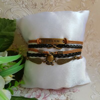 New, brown-black leatherette bracelet with metal decorations - infinity sign, winged skull, dream