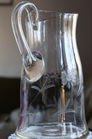 Old broken glass jug with flower pattern