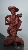 Wooden carved statue of a fisherman