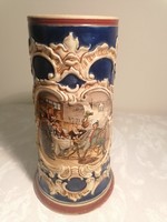 Antique German beer mug decorated with a painting of a pub - drinking scene, marked 1616 on the trunk.