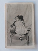 Old postcard photo of a little girl with a kitten