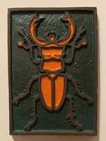 Wall ceramic with stag beetle pattern.