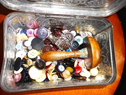Old metal box with sewing supplies (buttons, hitching stick)