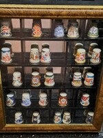 Royal Worcester English porcelain thimble collection in a wooden display case with a mirror insert, a collection of 25 pieces