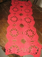 Beautiful hand-crocheted red tablecloth with a floral pattern