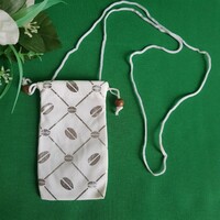 New retro textile phone case with a silver coffee bean pattern on a white background with a cord that can be hung around the neck