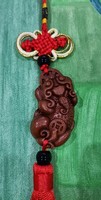 Real room. Feng shui rosewood pendant, amulet, material protection