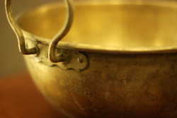 Yellow copper cauldron in patina condition