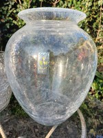 A large glass vase with a carved veil